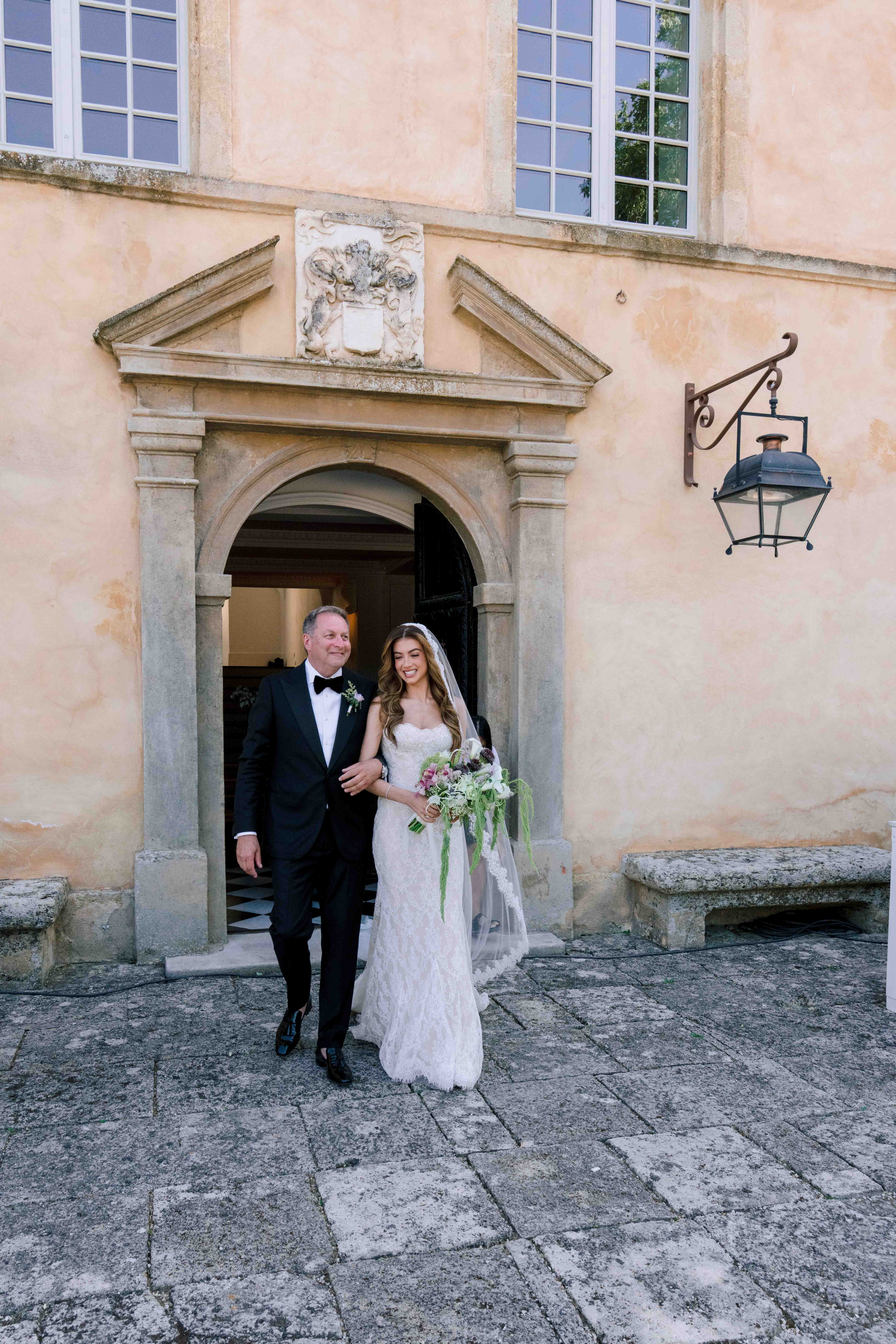 Bride and groom holding hands during their Provence wedding celebration